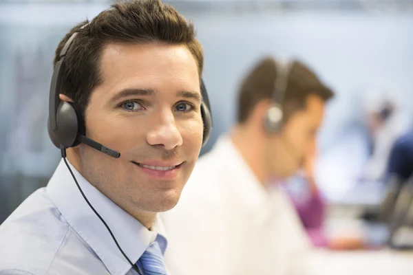 Businessman on phone with headset — Stock Photo, Image
