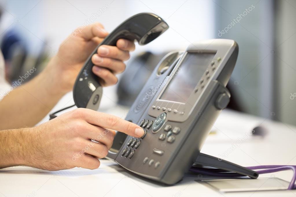 Man hand dialing phone number