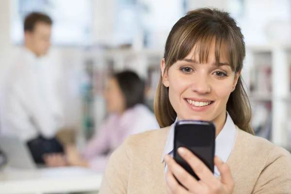 Businesswoman texting on mobile phone — Stock Photo, Image