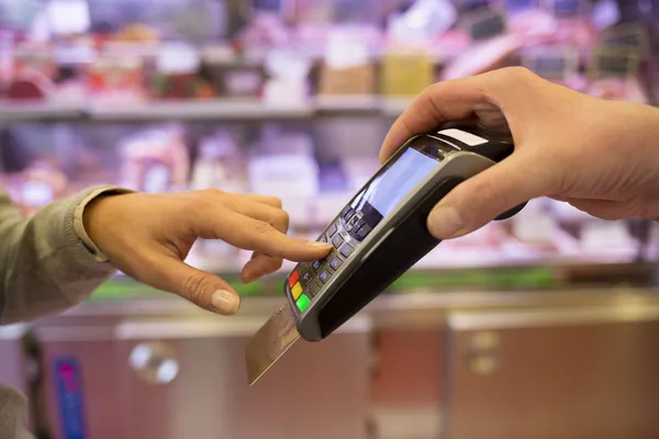 Woman entering password on POS terminal — Stock Photo, Image