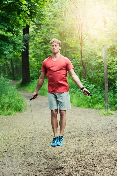 Young Sportman Exercising Jumping Rope Forest Background — Zdjęcie stockowe