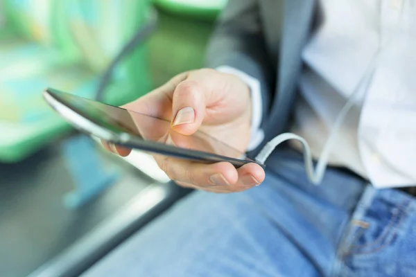 Man Using His Cell Phone Listen Music Bus Texting Message — Stockfoto