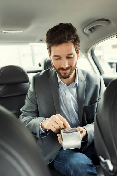 Man paying the taxi with the credit card