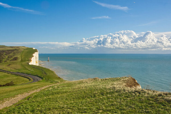 View to Beachy Head with lighthouse on South Downs near Eastbourne in East Sussex, England. No people.