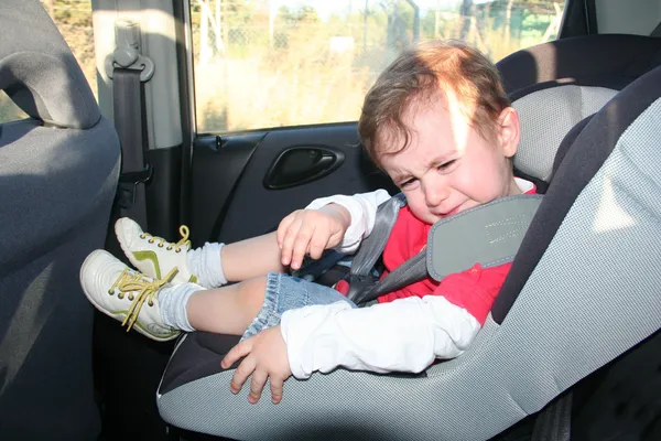 Baby in car seat for safety, unhappy