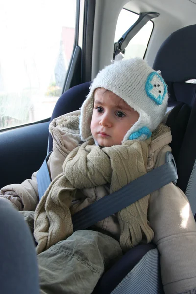 Baby in car seat for safety, looking outside — Stock Photo, Image