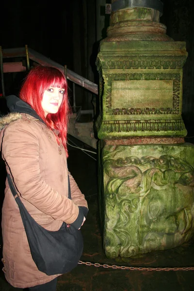 Meisje in de buurt van medusa beeldhouwkunst. foto genomen in basilica cisterne — Stockfoto
