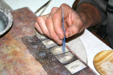 Worker hands making silver jewelery clipart