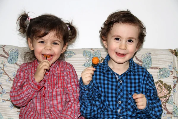 Eating candy and playing — Stock Photo, Image