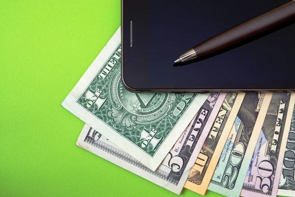 Cell phone, banknotes and pen — Stock Photo, Image