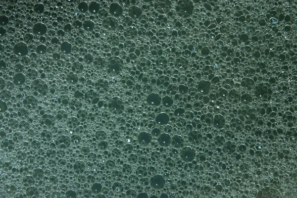 Konsistens av tvål vatten på en grå-blå bakgrund — Stockfoto
