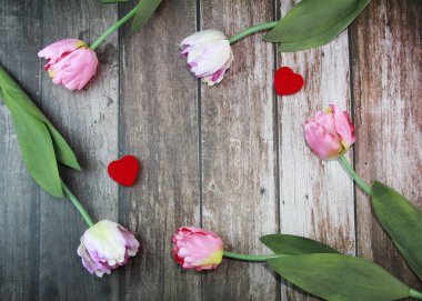 pink tulips and two red hearts