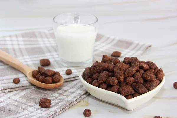 children\'s chocolate breakfast in the form of pillows and milk in a mug