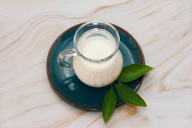 white fermented milk drink ayran in a transparent glass mug