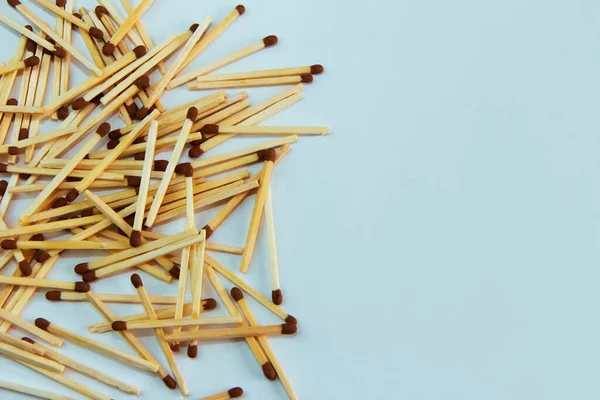 Yellow Wooden Matches Brown Sulfur Heads Blue Background — Stock fotografie