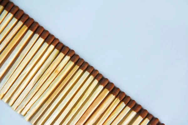 Yellow Wooden Matches Brown Sulfur Heads Blue Background — Stock fotografie