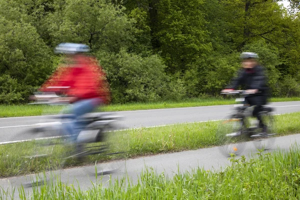 Active family riding bicycle in spring — Stock Photo, Image