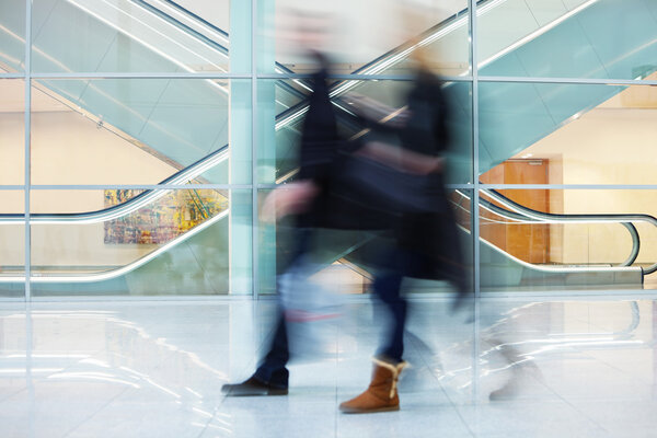 Intentional Blurred Image of Two Businesspeople in Office Buildi