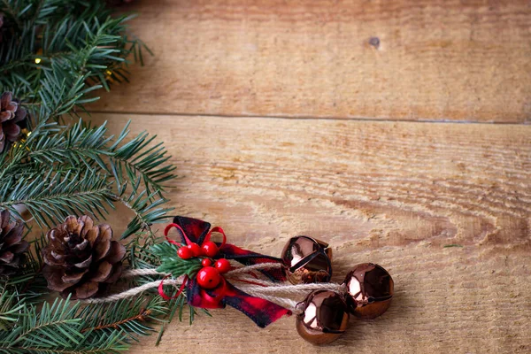 Christmas Background Spruce Branches Cones Bells Wooden Board — 图库照片