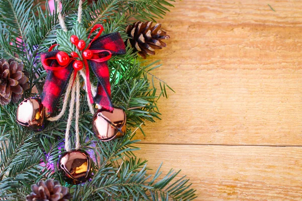 Christmas Background Spruce Branches Cones Bells Wooden Board — Fotografia de Stock