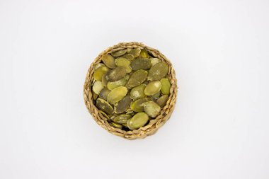 Kabak tohumları sepetin içinde, beyaz arkaplanda.