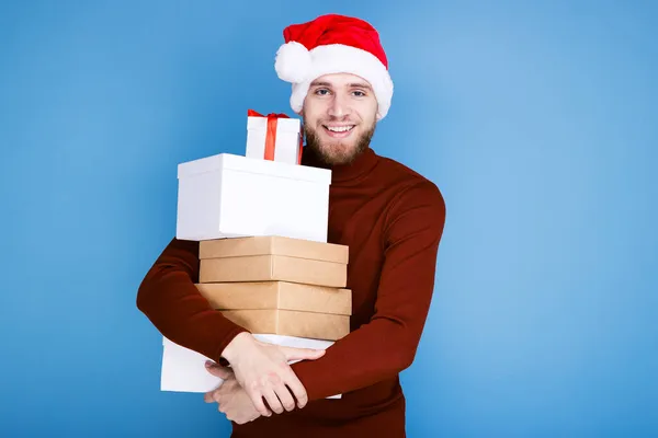 Portrait Man Red Hat Holding Gift Boxes Blue Background — Stock Photo, Image