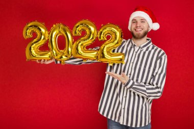 2022 numaralı Noel şapkalı bir adam. Yeni yıl yaklaşıyor.