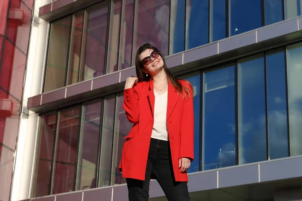 Retrato Uma Jovem Mulher Uma Jaqueta Vermelha Fundo Edifícios Vidro — Fotografia de Stock