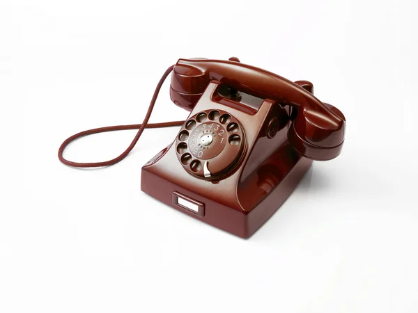 Viejo teléfono rojo sobre un fondo blanco — Foto de Stock