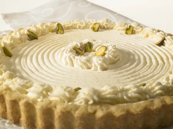 Rare Cheese Tart with pistachio nuts and whipped cream Royalty Free Stock Images