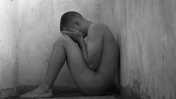 Frightened and naked young boy in the corner — Stock Photo, Image
