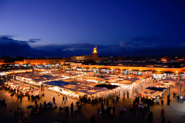 Evening busy market square Djemaa El Fna in Marrakesh, Morocco.