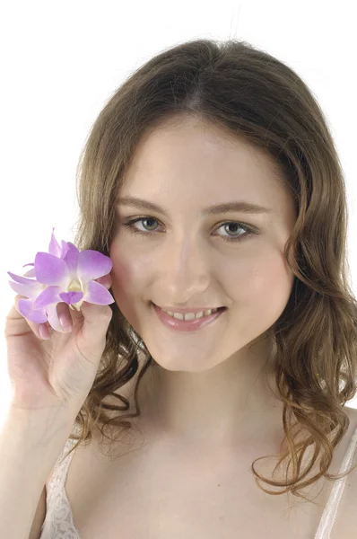 Mulher com uma orquídea rosa — Fotografia de Stock