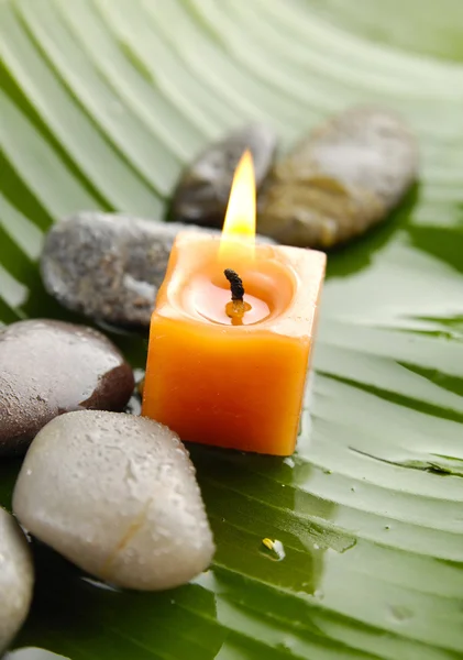 Candle and stones — Stock Photo, Image