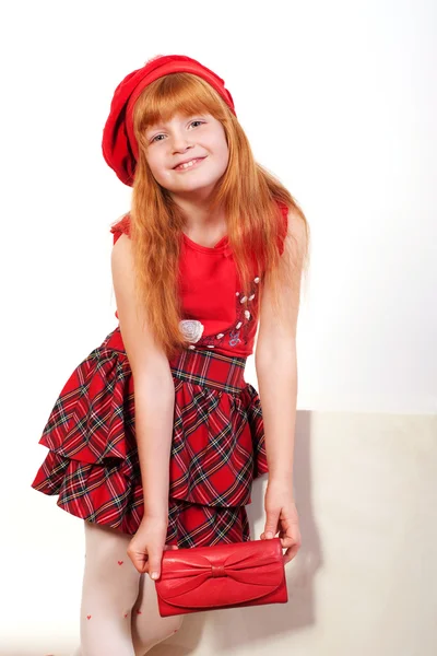 Little redheaded girl in red — Stock Photo, Image