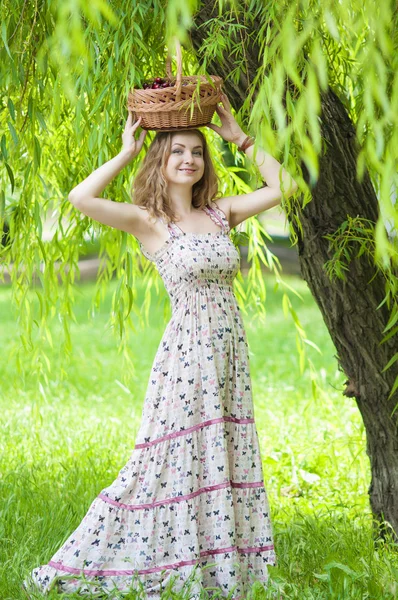 Junge Frau mit einem Korb Kirschen — Stockfoto