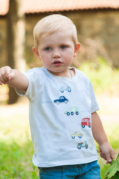 Criança andando no parque com um brinquedo — Fotografia de Stock
