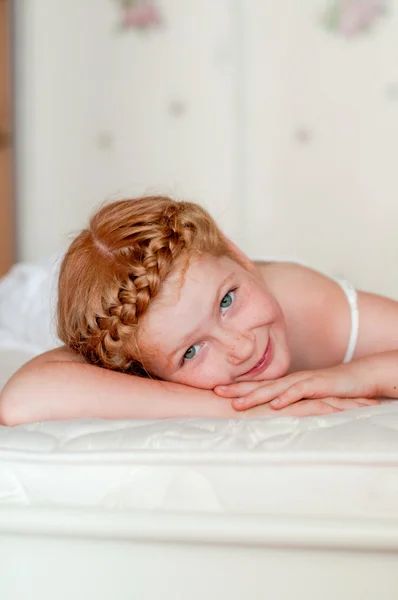 Little girl with red hair in a white dress — Stock Photo, Image