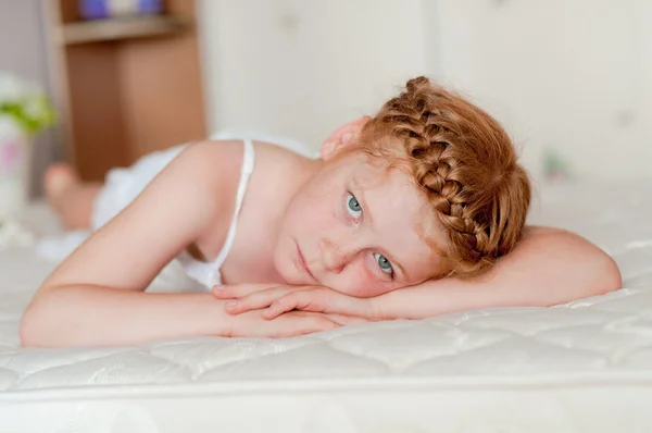 Little girl with red hair in a white dress — Stock Photo, Image