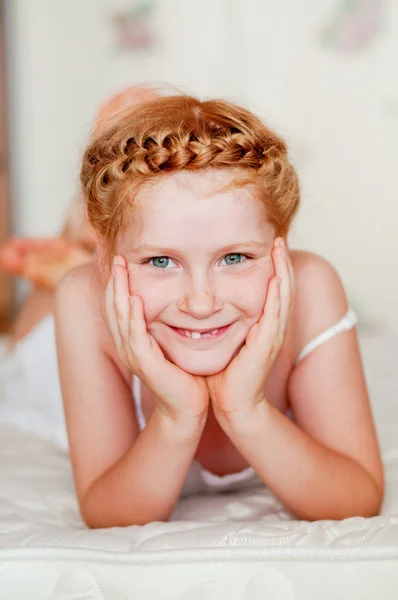 Little girl with red hair in a white dress — Stock Photo, Image