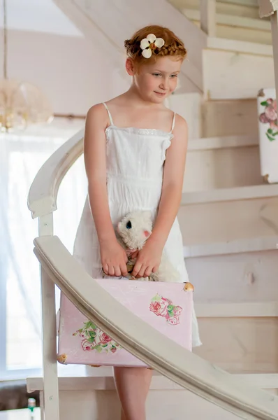 Little girl with a suitcase on the stairs — Stok fotoğraf