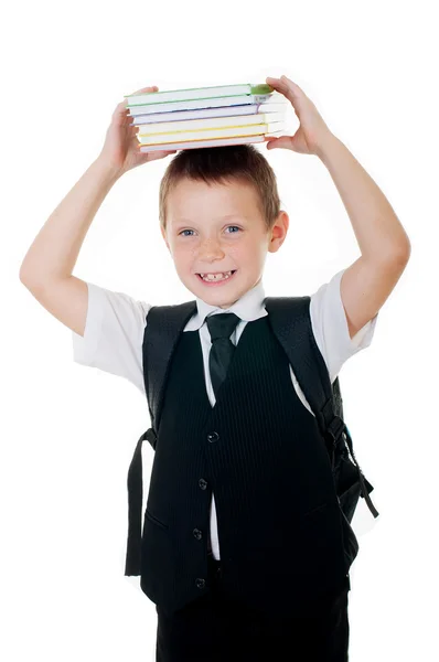 Маленький мальчик с книгами на голове на белом фоне — стоковое фото