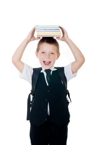 Niño con libros en la cabeza sobre fondo blanco —  Fotos de Stock