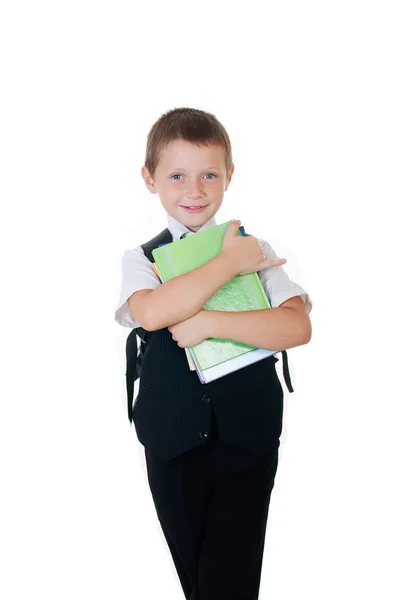 Niño pequeño con una mochila escolar y libros sobre fondo blanco —  Fotos de Stock