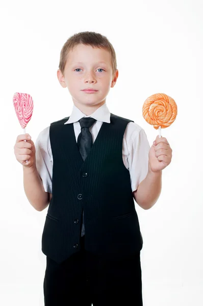 Little boy with big candy on white background — Stock Photo, Image