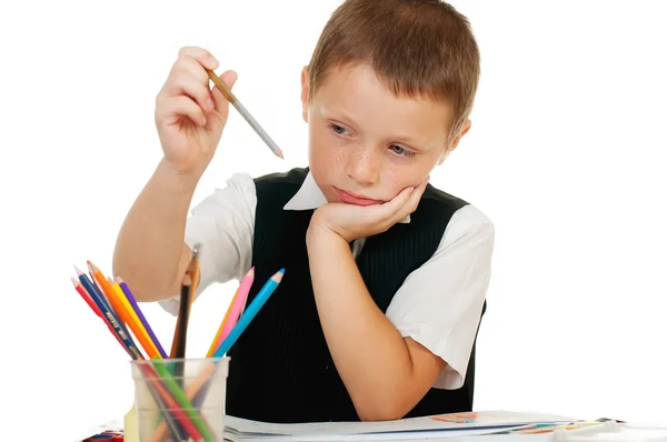 The boy draws pencils in an album on a white background — Stock Photo, Image