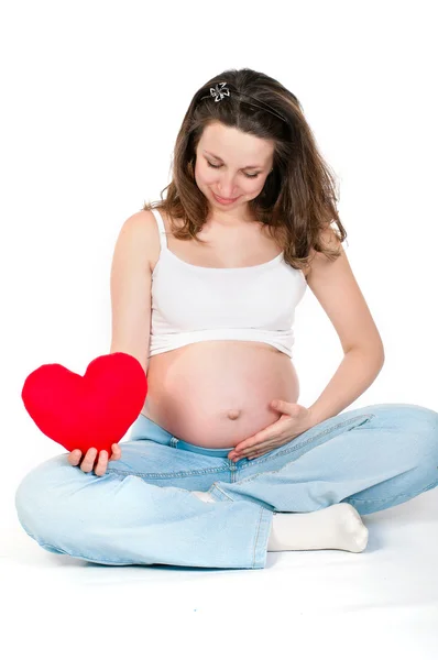 Jonge zwangere vrouw op een witte achtergrond — Stockfoto