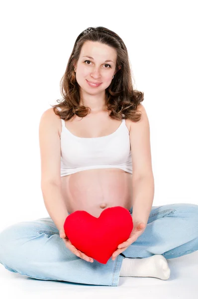 Young pregnant woman on a white background — Stock Photo, Image