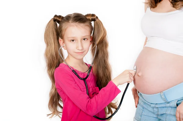 Kind luisteren buik van zwangere moeder — Stockfoto