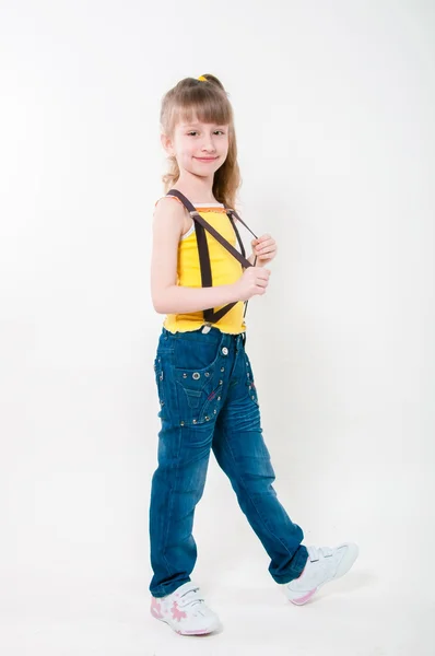 Little girl in jeans on a white background — Stock Photo, Image
